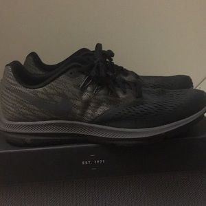 Grey and black Nike running shoes.